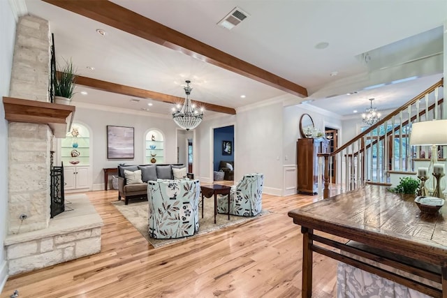 7503 Stonecliff Cir, Austin, TX 78731 - living room featuring a chandelier, stairway, beam ceiling, light wood-style flooring, and crown molding