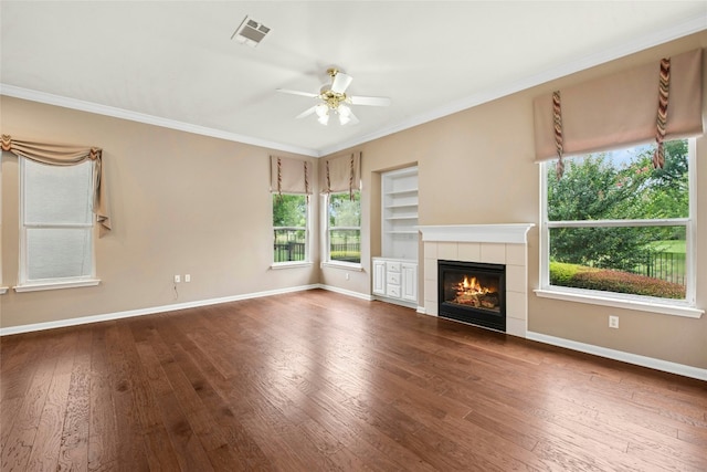 130 Enchanted Dr, Georgetown, TX 78633 - unfurnished living room featuring wood-type flooring, ornamental molding, a fireplace, a ceiling fan, and built in features