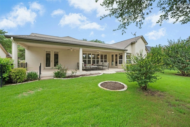 130 Enchanted Dr, Georgetown, TX 78633 - back of house with french doors, a ceiling fan, stucco siding, a lawn, and a patio area