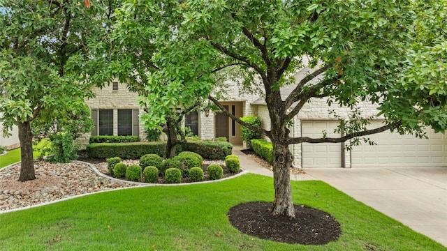 130 Enchanted Dr, Georgetown, TX 78633 - obstructed view of property with stone siding, concrete driveway, and a front lawn