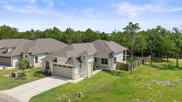 147 William Hersee Dr, Bastrop, TX 78602 - view of front of property with an attached garage, driveway, roof with shingles, and stucco siding