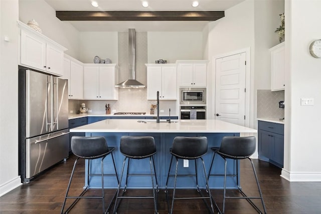 147 William Hersee Dr, Bastrop, TX 78602 - kitchen featuring appliances with stainless steel finishes, wall chimney exhaust hood, white cabinetry, beamed ceiling, and backsplash