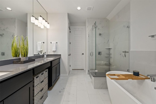 147 William Hersee Dr, Bastrop, TX 78602 - bathroom with a shower stall, a freestanding bath, double vanity, marble look tile flooring, and recessed lighting