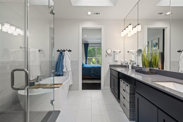 147 William Hersee Dr, Bastrop, TX 78602 - ensuite bathroom with double vanity, a freestanding bath, a shower stall, and recessed lighting
