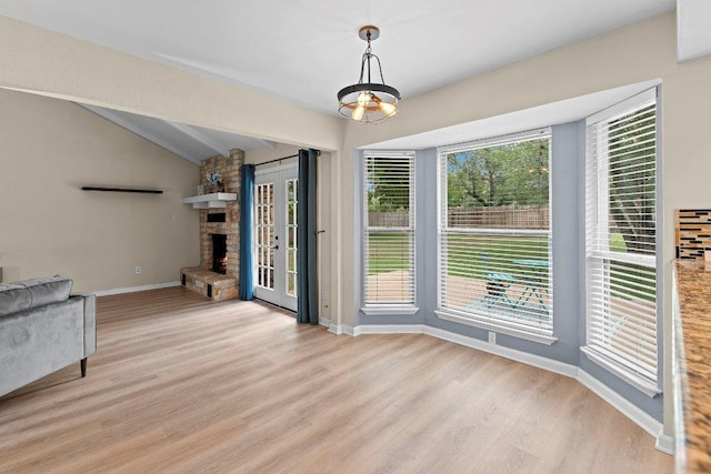 907 Great Oaks Cv, Round Rock, TX 78681 - unfurnished dining area featuring light wood-style floors and a stone fireplace