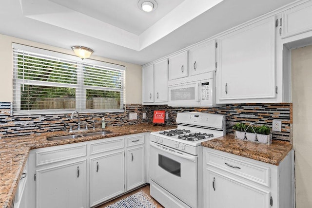 907 Great Oaks Cv, Round Rock, TX 78681 - kitchen featuring white appliances, decorative backsplash, and white cabinets