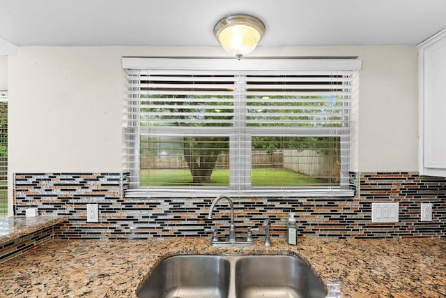 907 Great Oaks Cv, Round Rock, TX 78681 - kitchen view of decorative backsplash, stone counters, and white cabinets