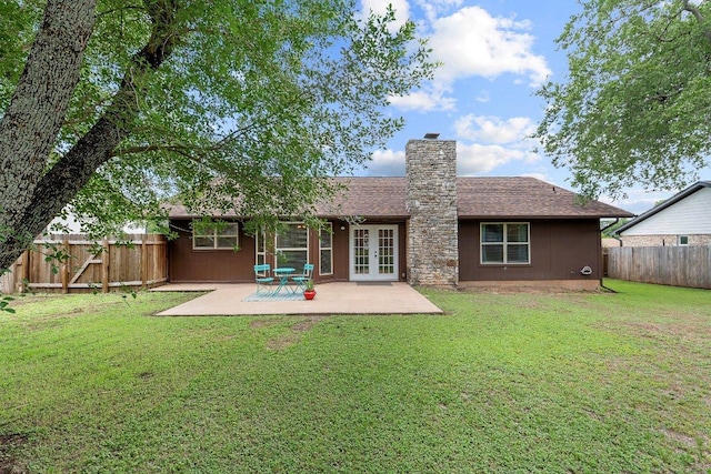 907 Great Oaks Cv, Round Rock, TX 78681 - back of property featuring french doors, a chimney, a fenced backyard, a patio, and roof with shingles