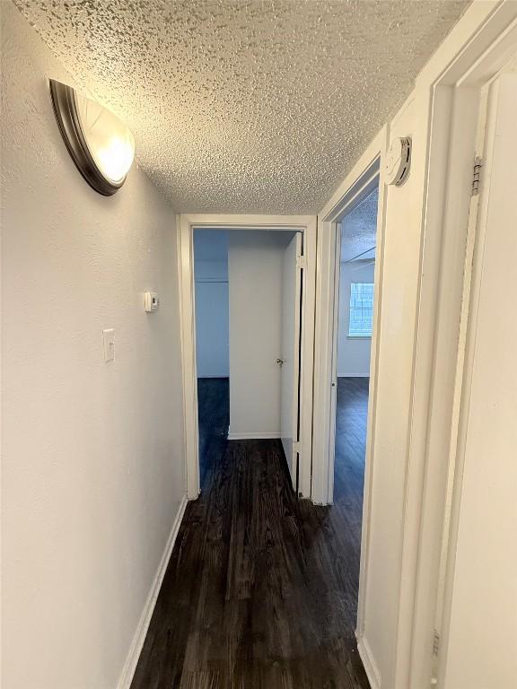 2704 Salado St Unit 207, Austin, TX 78705 - hallway with a textured ceiling and dark wood-style floors