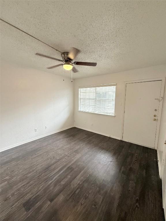 2704 Salado St Unit 207, Austin, TX 78705 - empty room with a ceiling fan, dark wood-type flooring, and a textured ceiling