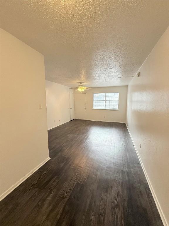 2704 Salado St Unit 207, Austin, TX 78705 - unfurnished room with dark wood-type flooring, a ceiling fan, and a textured ceiling