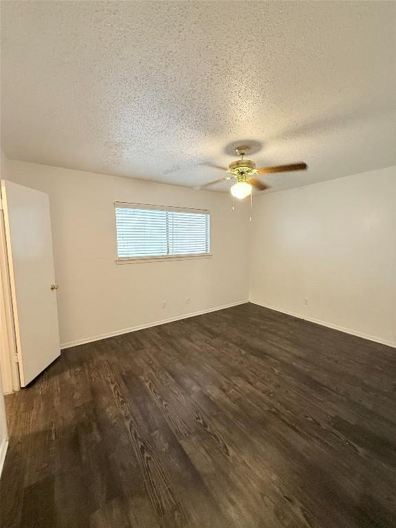 2704 Salado St Unit 207, Austin, TX 78705 - empty room featuring dark wood-style floors, a textured ceiling, and ceiling fan