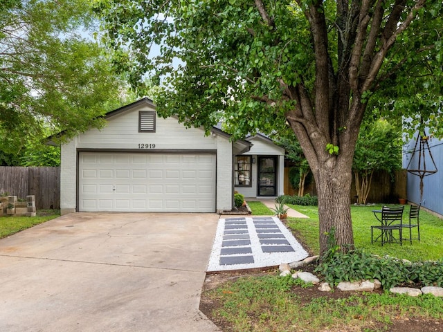 12919 Margit Dr, Austin, TX 78729 - mid-century home with concrete driveway, an attached garage, and brick siding