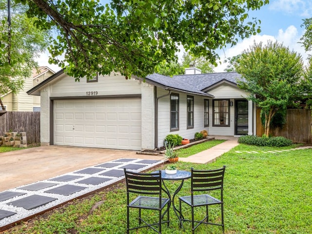 12919 Margit Dr, Austin, TX 78729 - single story home featuring an attached garage, driveway, a shingled roof, and a chimney