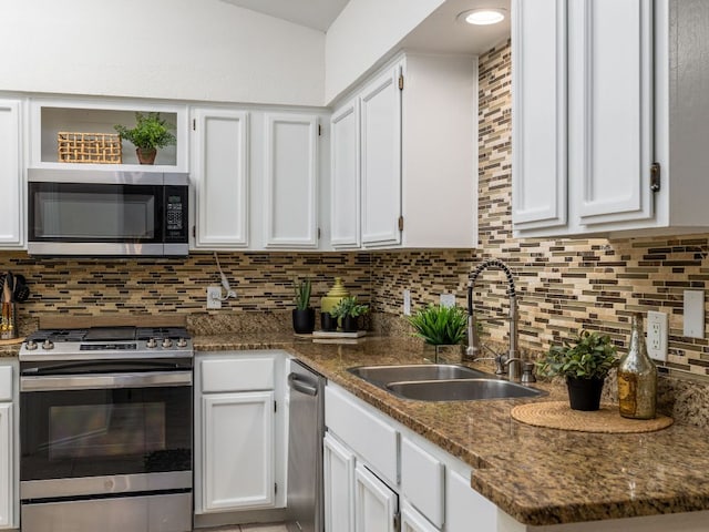 12919 Margit Dr, Austin, TX 78729 - kitchen with stainless steel appliances, white cabinetry, and decorative backsplash