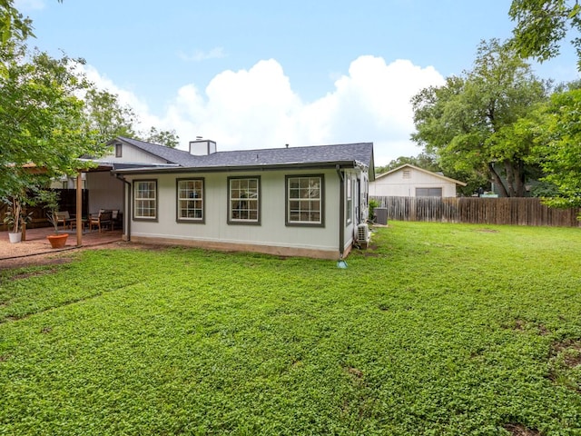 12919 Margit Dr, Austin, TX 78729 - rear view of house with a chimney and a patio