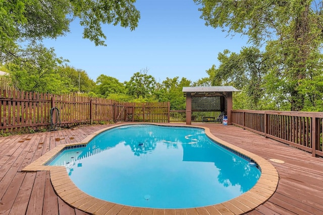 6819 Bayridge Ter, Austin, TX 78759 - view of pool featuring a wooden deck, a fenced backyard, view of wooded area, and a gazebo