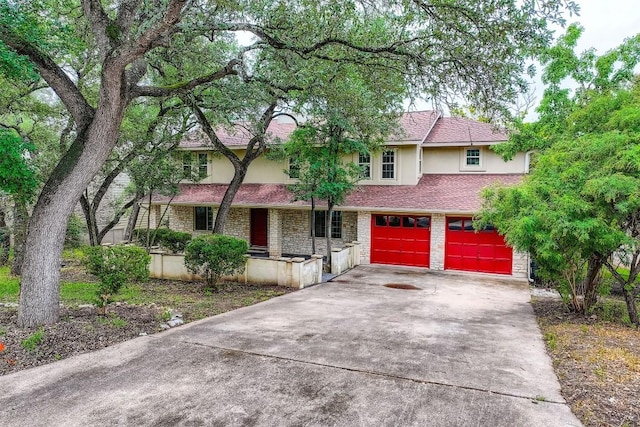 6819 Bayridge Ter, Austin, TX 78759 - view of front facade with stucco siding, driveway, an attached garage, and covered porch