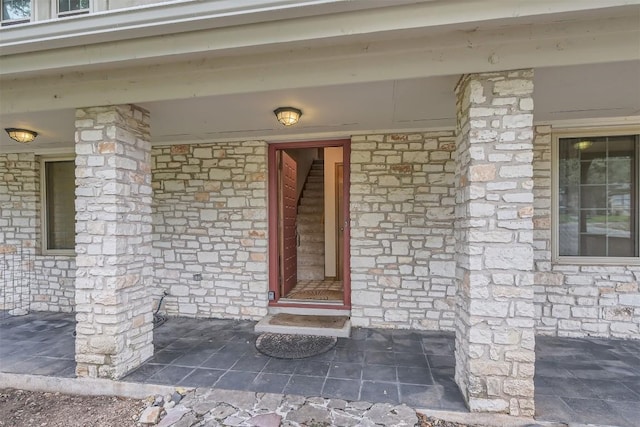 6819 Bayridge Ter, Austin, TX 78759 - view of exterior entry featuring covered porch and stone siding