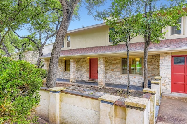 6819 Bayridge Ter, Austin, TX 78759 - view of front facade featuring a porch, stucco siding, stone siding, and a shingled roof