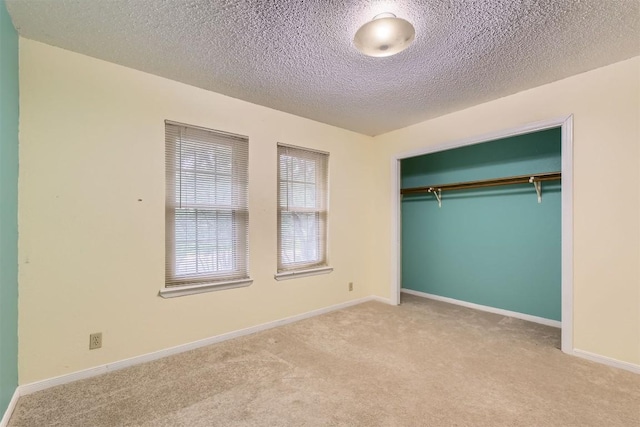 6819 Bayridge Ter, Austin, TX 78759 - unfurnished bedroom with carpet flooring, a textured ceiling, and a closet