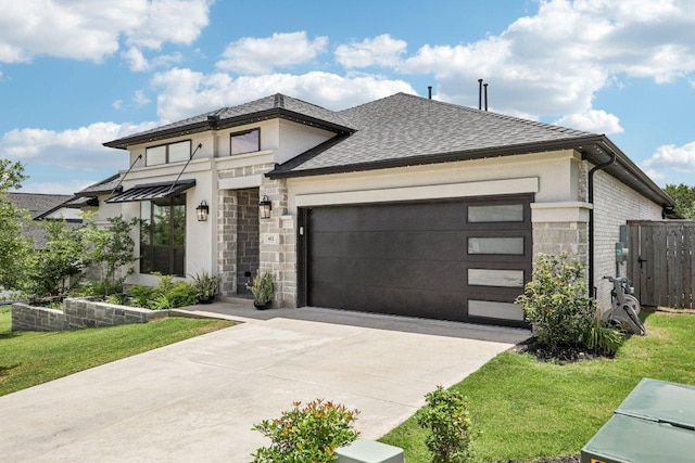 412 Pin Cherry Pass, San Marcos, TX 78666 - modern home featuring stone siding, concrete driveway, an attached garage, and roof with shingles