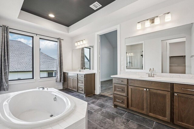 412 Pin Cherry Pass, San Marcos, TX 78666 - full bath with two vanities, a bath, and a raised ceiling