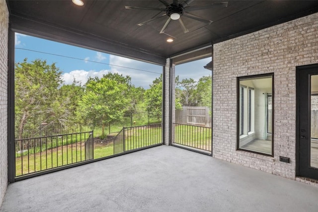 412 Pin Cherry Pass, San Marcos, TX 78666 - unfurnished sunroom with a ceiling fan and view of scattered trees