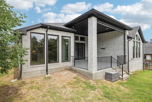 412 Pin Cherry Pass, San Marcos, TX 78666 - rear view of house featuring a lawn and brick siding