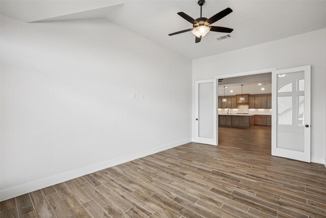 412 Pin Cherry Pass, San Marcos, TX 78666 - empty room with dark wood finished floors, ceiling fan, and lofted ceiling