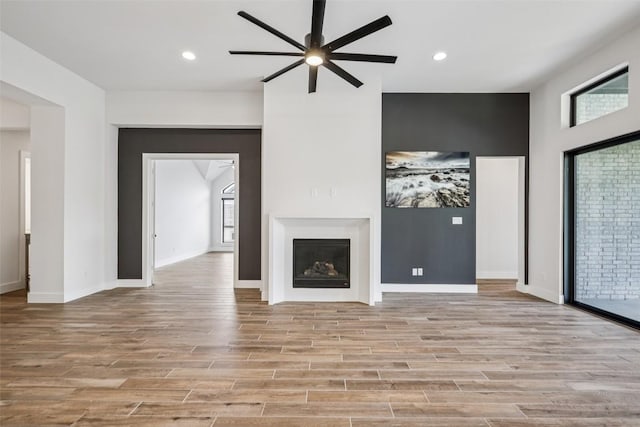 412 Pin Cherry Pass, San Marcos, TX 78666 - unfurnished living room with ceiling fan, plenty of natural light, light wood-style flooring, and recessed lighting