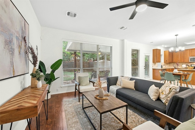 11024 Mint Julep Dr, Austin, TX 78748 - living area featuring a ceiling fan, dark wood-type flooring, and a chandelier
