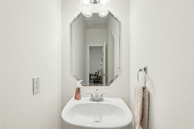 11024 Mint Julep Dr, Austin, TX 78748 - bathroom featuring a sink and a textured wall