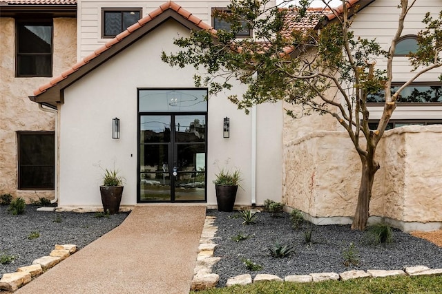 3901 Peak Lookout Dr, Austin, TX 78738 - entrance to property with french doors, a tile roof, and stucco siding