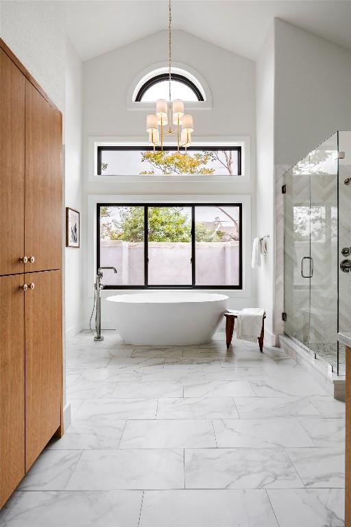 3901 Peak Lookout Dr, Austin, TX 78738 - full bath with a chandelier, high vaulted ceiling, a freestanding bath, marble finish floors, and a stall shower
