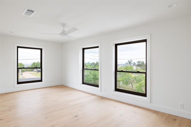 3901 Peak Lookout Dr, Austin, TX 78738 - unfurnished room featuring healthy amount of natural light, light wood-type flooring, and a ceiling fan