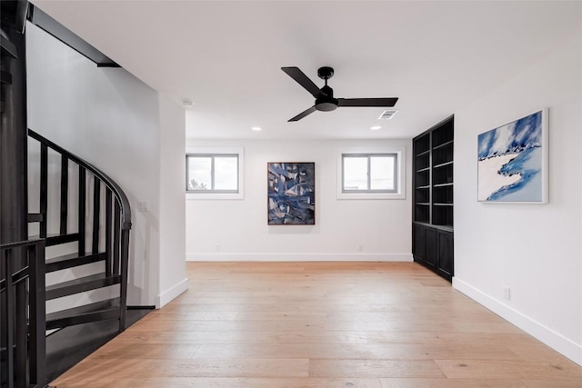 3901 Peak Lookout Dr, Austin, TX 78738 - unfurnished living room with stairway, a ceiling fan, built in shelves, light wood finished floors, and recessed lighting