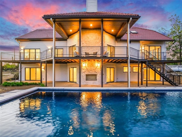 3901 Peak Lookout Dr, Austin, TX 78738 - rear view of house with a tile roof, stairway, and a patio