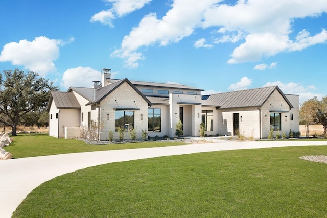439 Junker Hl, Fredericksburg, TX 78624 - modern inspired farmhouse featuring a front yard, stone siding, a metal roof, a standing seam roof, and a chimney