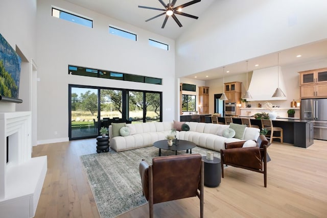 439 Junker Hl, Fredericksburg, TX 78624 - living area with a towering ceiling, light wood finished floors, and a ceiling fan