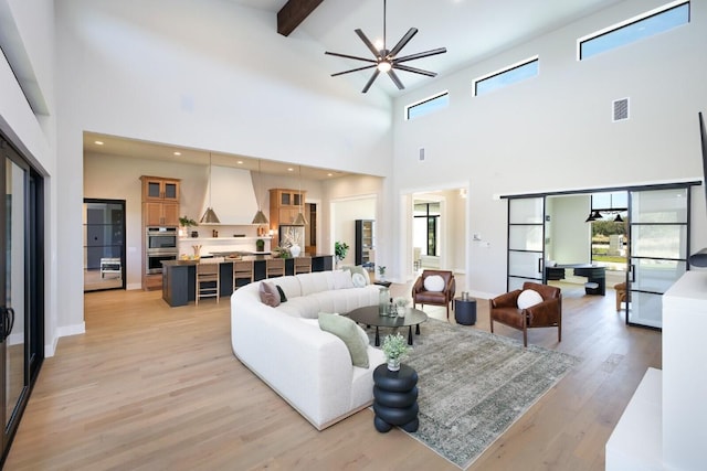 439 Junker Hl, Fredericksburg, TX 78624 - living area with a towering ceiling, plenty of natural light, light wood finished floors, beam ceiling, and ceiling fan
