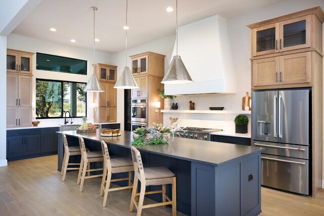 439 Junker Hl, Fredericksburg, TX 78624 - kitchen featuring stainless steel appliances, light wood-style floors, recessed lighting, a center island, and a breakfast bar