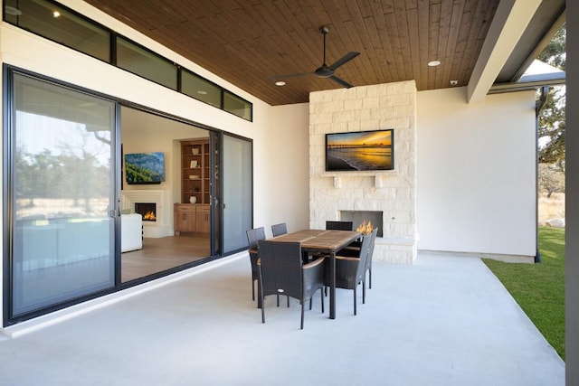 439 Junker Hl, Fredericksburg, TX 78624 - view of patio featuring an outdoor stone fireplace, ceiling fan, and outdoor dining area