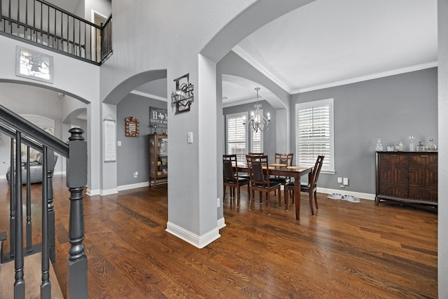 15413 Echo Hills Dr, Austin, TX 78717 - dining space featuring wood finished floors, crown molding, a chandelier, arched walkways, and stairway