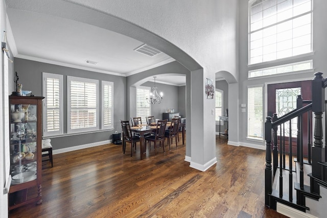 15413 Echo Hills Dr, Austin, TX 78717 - entryway with arched walkways, ornamental molding, wood finished floors, and a chandelier