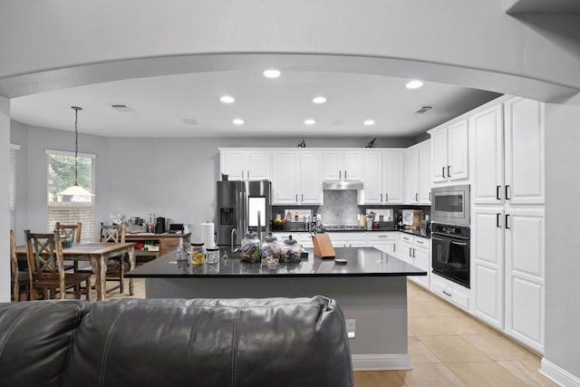 15413 Echo Hills Dr, Austin, TX 78717 - kitchen with appliances with stainless steel finishes, dark countertops, recessed lighting, light tile patterned floors, and white cabinetry