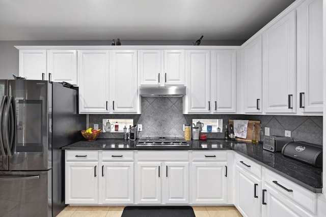 15413 Echo Hills Dr, Austin, TX 78717 - kitchen featuring stainless steel appliances, white cabinets, backsplash, light tile patterned flooring, and under cabinet range hood