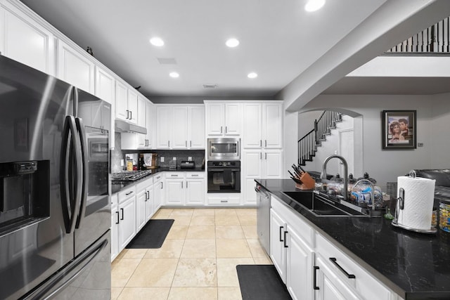 15413 Echo Hills Dr, Austin, TX 78717 - kitchen with stainless steel appliances, arched walkways, tasteful backsplash, white cabinets, and recessed lighting