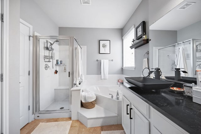 15413 Echo Hills Dr, Austin, TX 78717 - bathroom featuring a stall shower, a garden tub, vanity, and tile patterned floors