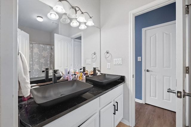 15413 Echo Hills Dr, Austin, TX 78717 - full bathroom with double vanity and wood finished floors